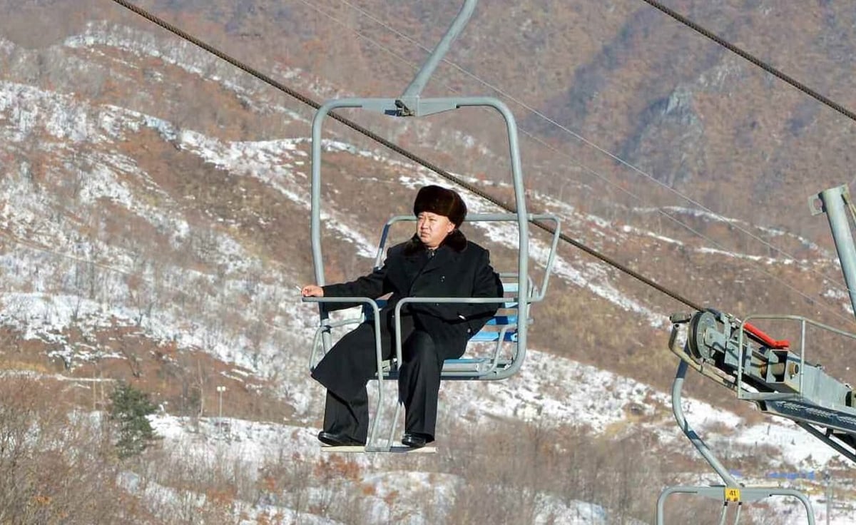 A man riding skis down a snow covered mountain