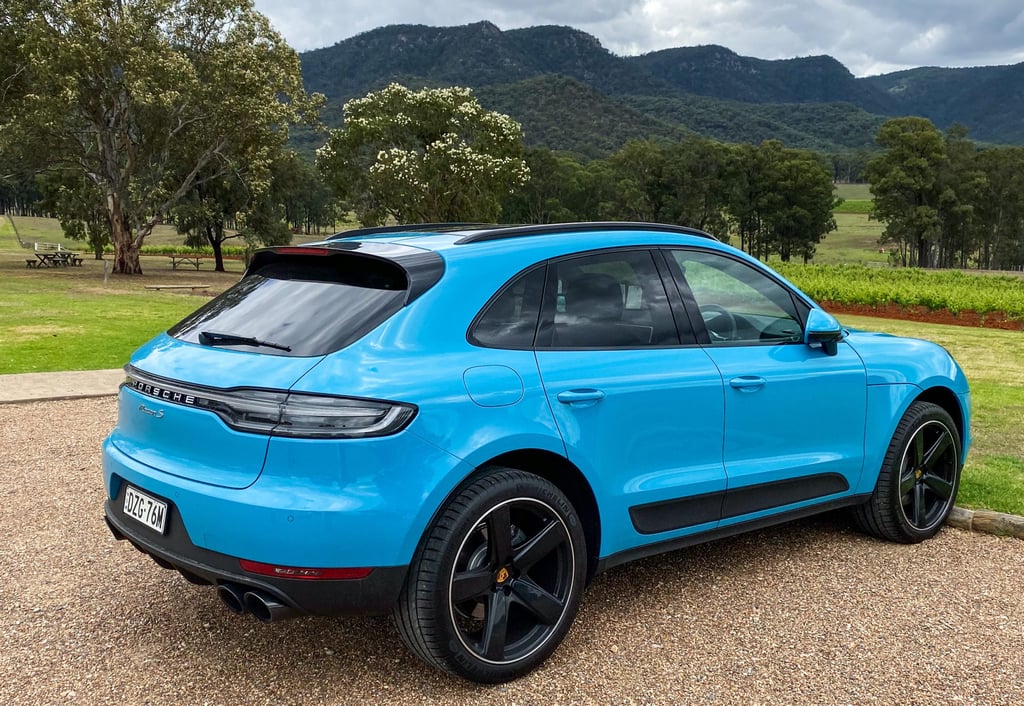 A blue car parked in a parking lot