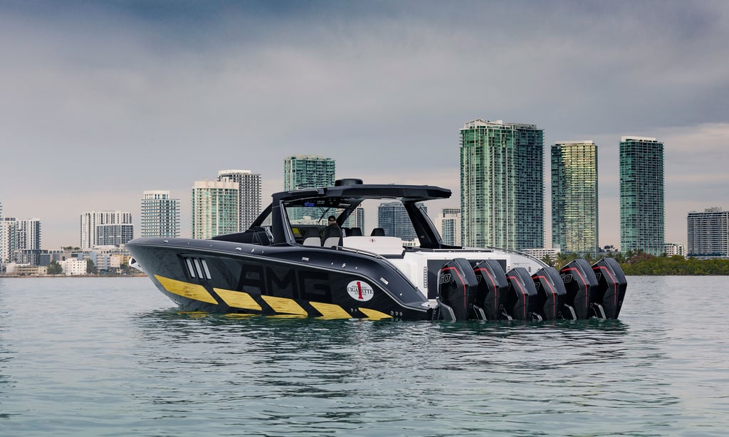 A small boat in a body of water with a city in the background