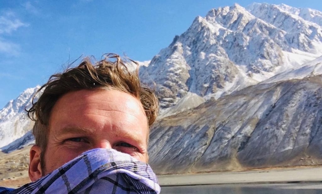 A man standing in front of a mountain