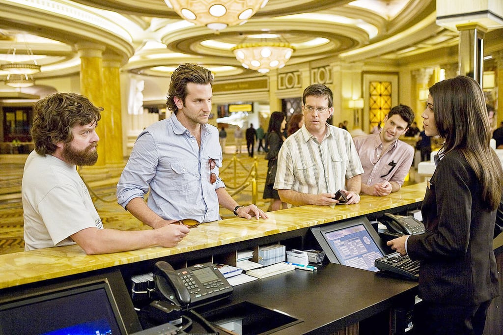 A group of people standing around a table