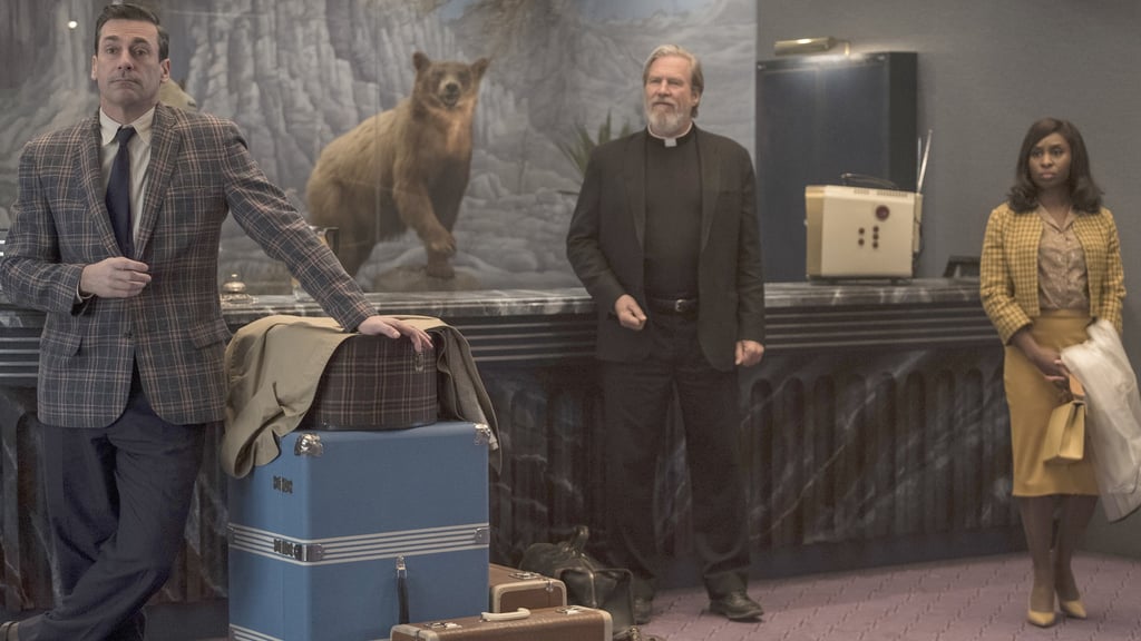 A man standing next to a suitcase