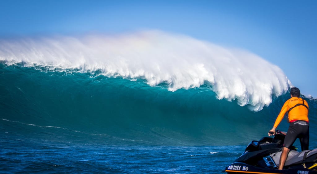 A man riding a wave on a surfboard in the ocean