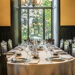 A dining room table in front of a window