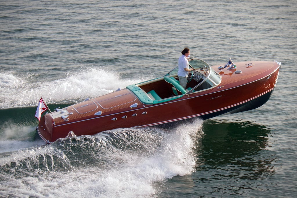 A man riding on the back of a boat in a body of water