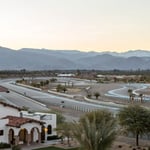 A large building with a mountain in the background