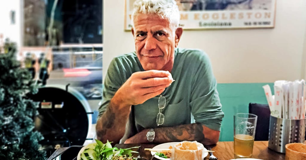 A man sitting at a table with a plate of food