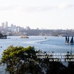 A large body of water with a city in the background