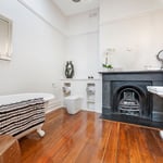 A living room with a sink and a mirror