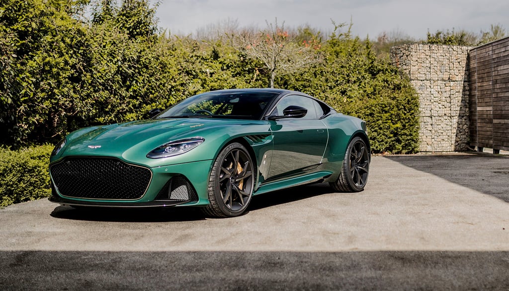 A green car parked on the side of a road