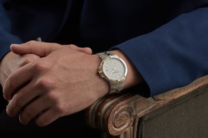 A hand holding a clock
