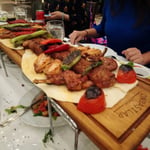 A woman sitting at a table with a plate of food