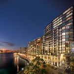 A bridge over a body of water with a city in the background