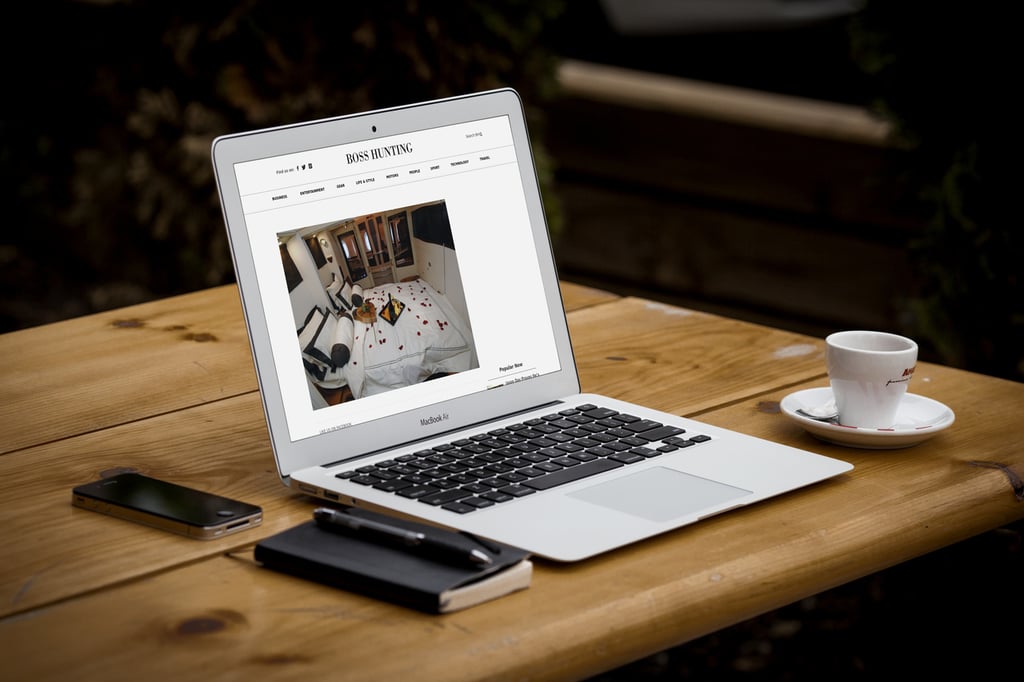 A laptop computer sitting on top of a wooden table