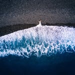 A man riding a wave on a surfboard in the water