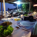 A group of people sitting at a table full of food