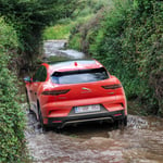 A car parked on the side of a river