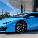 A blue car parked in a parking lot