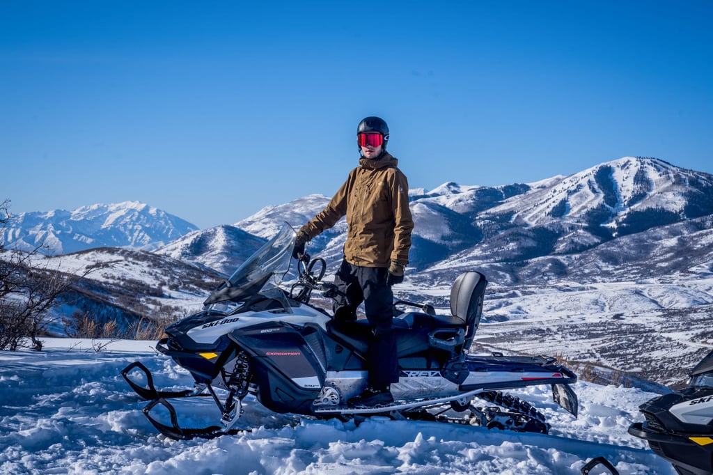 A man standing on top of a snow covered mountain