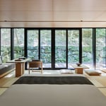 A view of a living room filled with furniture and a large window