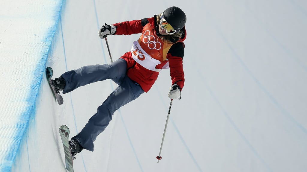 A person riding skis down a snow covered slope