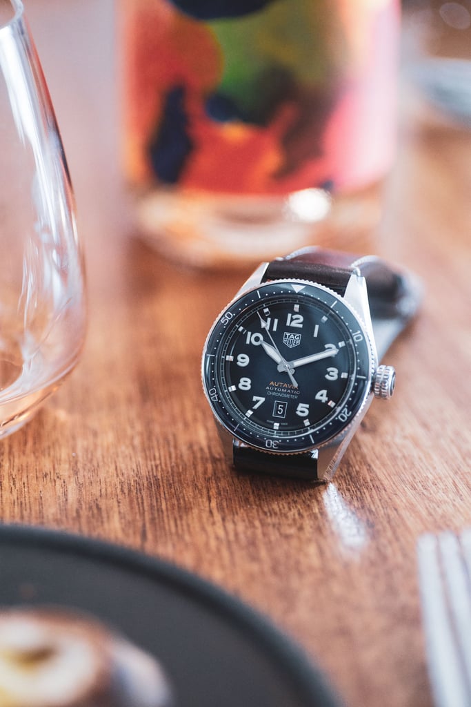 A clock sitting on top of a wooden table