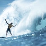 A man riding a wave on a surfboard in the water