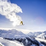 A group of people standing on top of a snow covered mountain