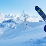 A man standing on top of a snow covered mountain