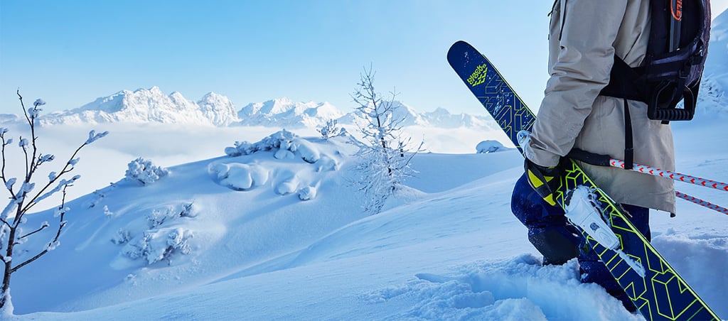 A man standing on top of a snow covered mountain