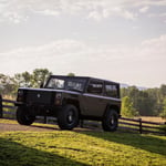 A truck is parked in a grassy field