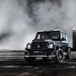 A steam engine driving down a dirt road