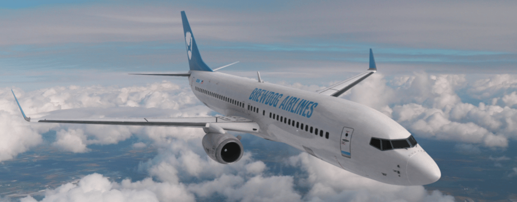 A large passenger jet flying through a cloudy blue sky