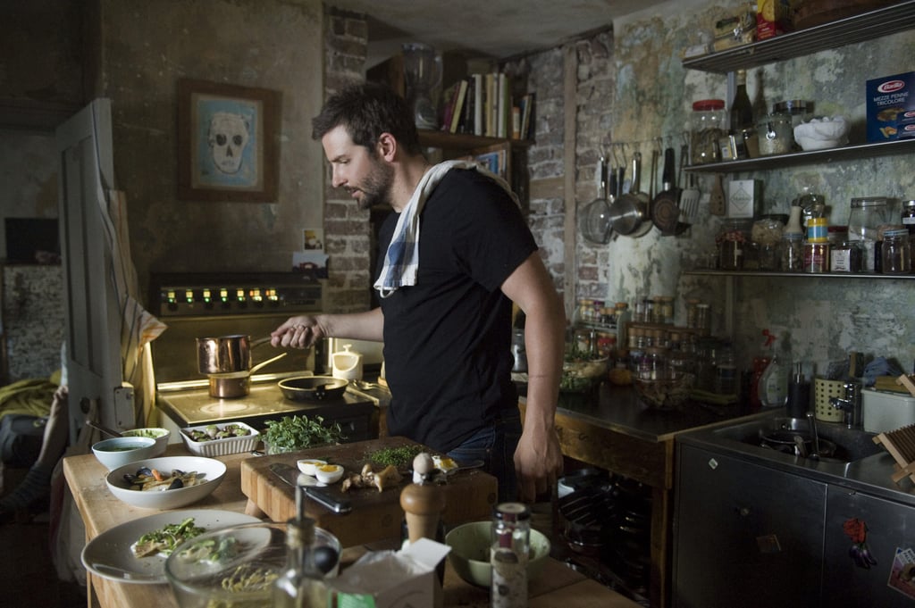 A person standing in a kitchen preparing food