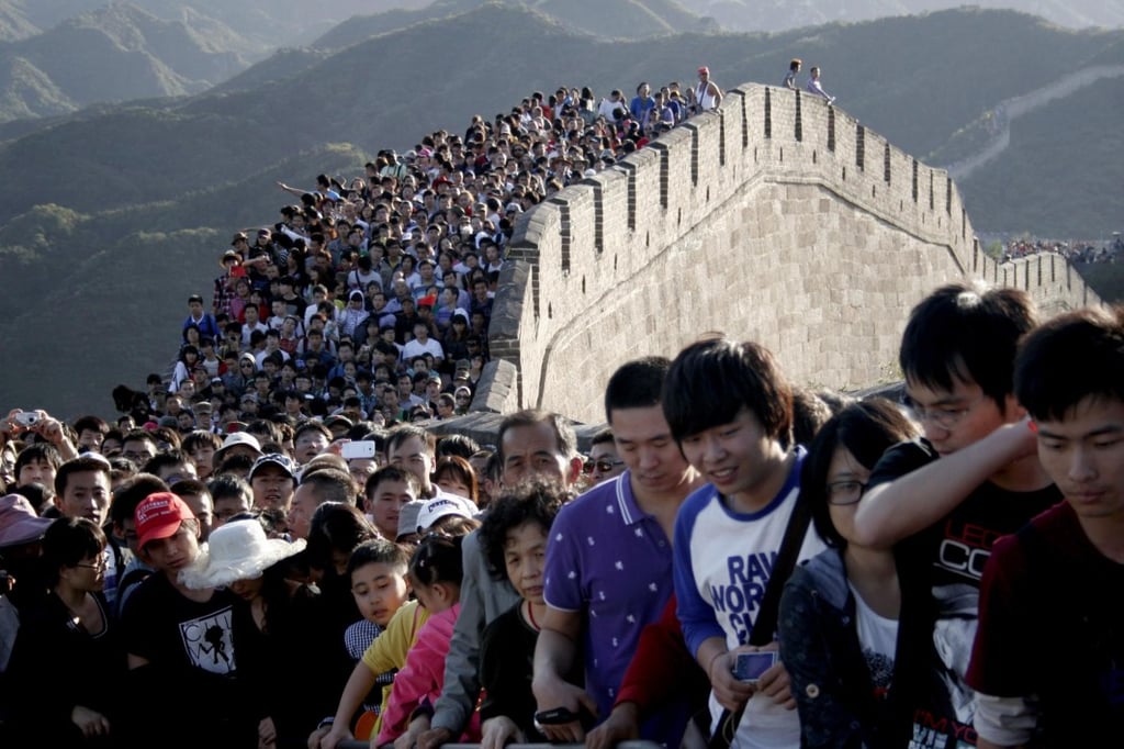 A group of people standing in front of a large crowd of people