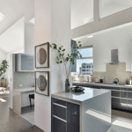 A kitchen with a sink and a mirror