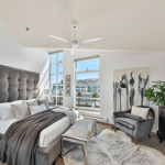 A living room filled with furniture and a bed in a bedroom