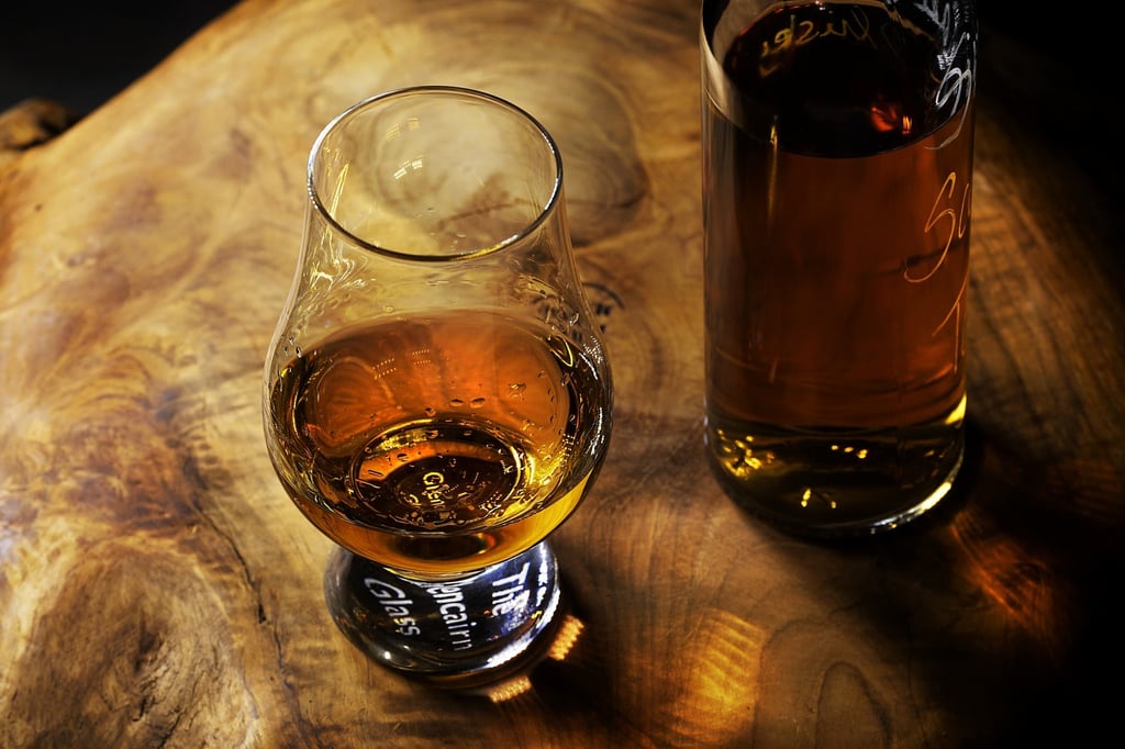 A glass of wine sitting on top of a wooden table