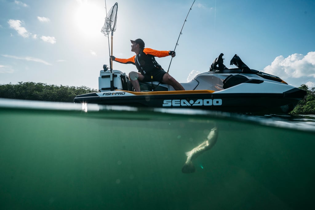 A man riding on the back of a boat