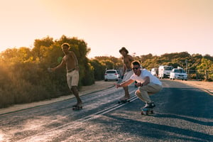A man riding a skateboard up the side of a road