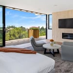 A hotel room with a bed and a large window