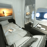 A bedroom with a computer on a table
