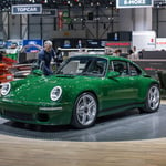 A green car parked on the side of a road