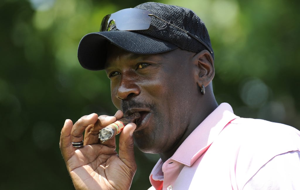 A man wearing a hat talking on a cell phone