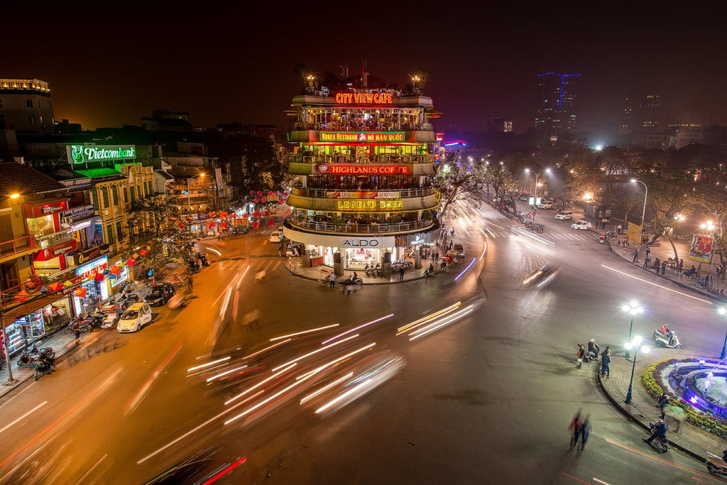 A view of a city street filled with traffic at night