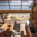 A wooden table next to a window