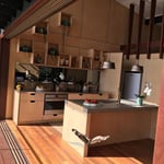 A kitchen with a table in a room