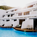 A blue and white boat sitting next to a pool of water