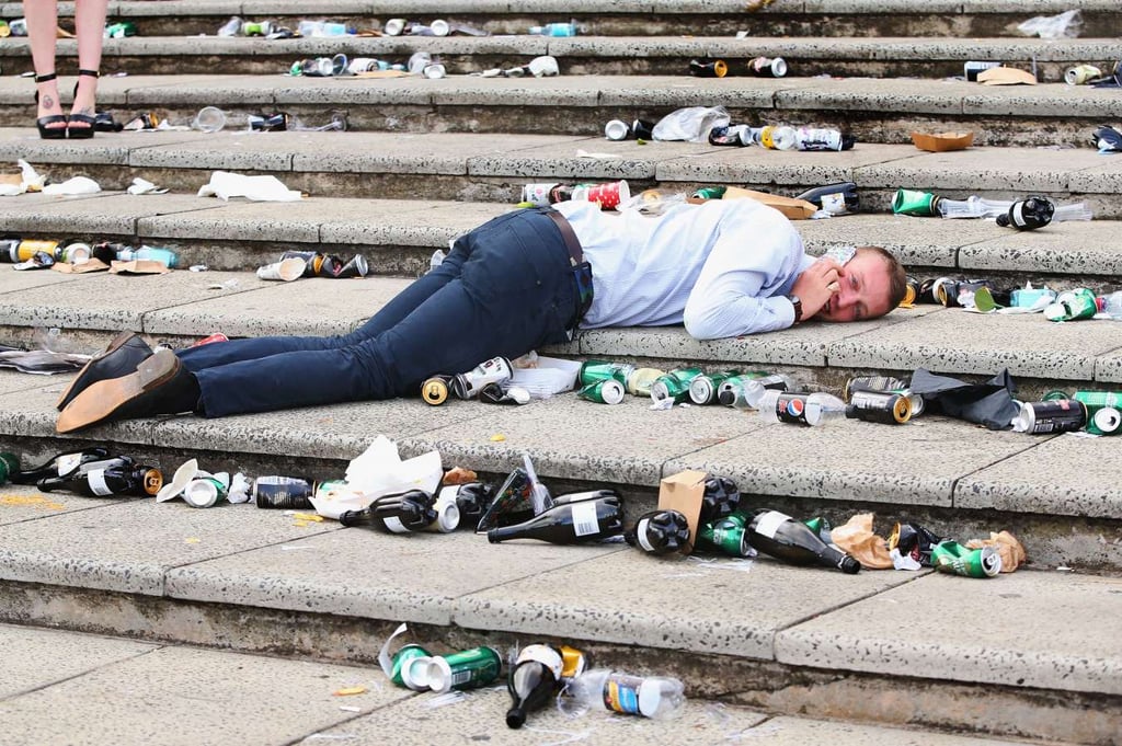 A group of people lying on a sidewalk