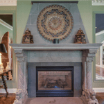 A fireplace in a living room filled with furniture and a fire place